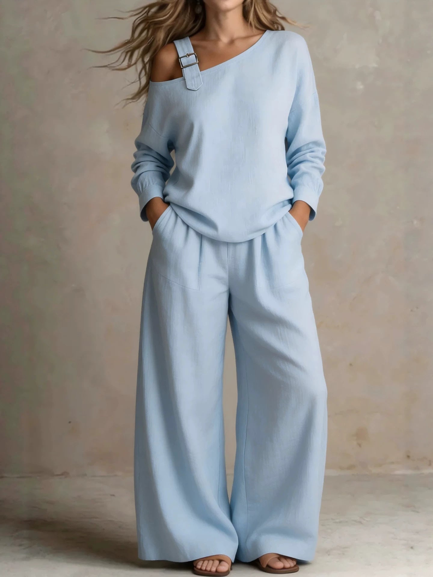 Woman wearing blue asymmetric buckle top and wide-leg pants lounge set