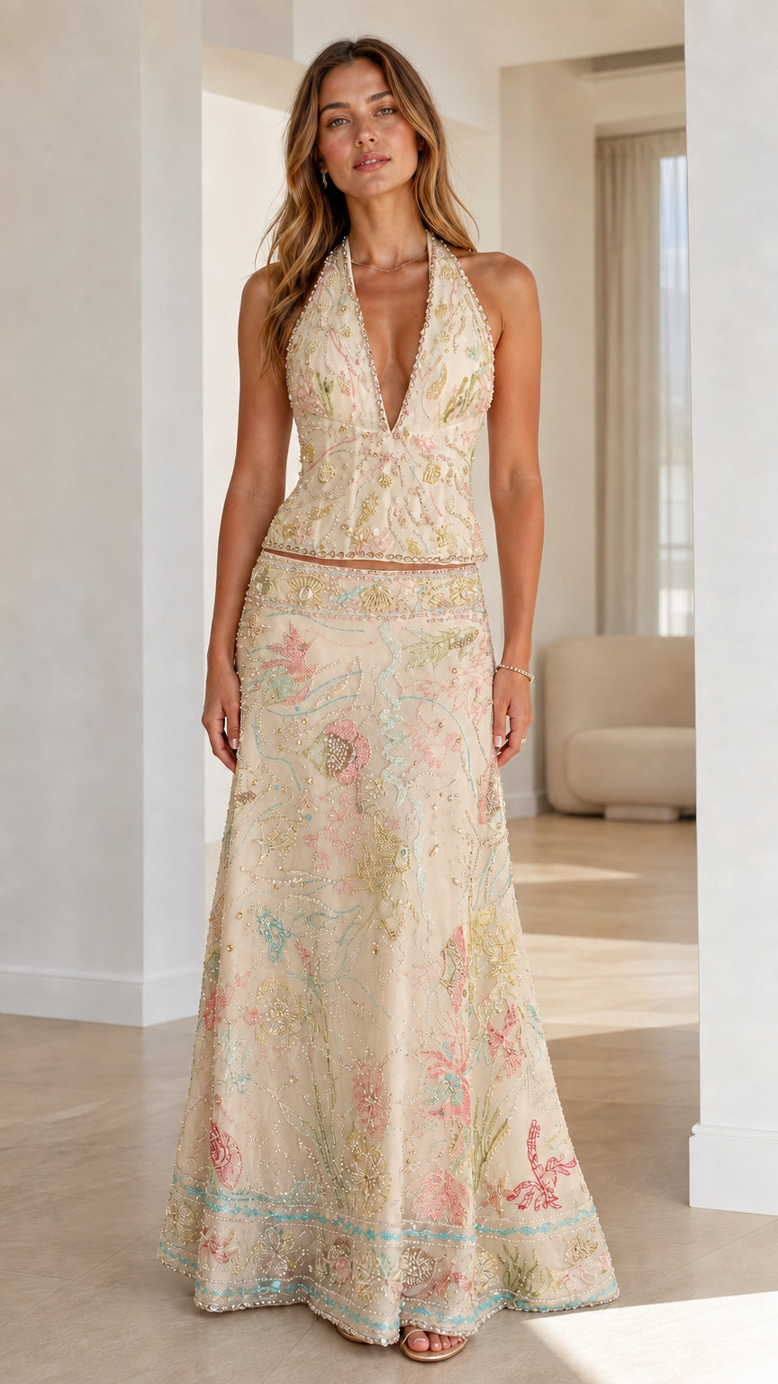 Woman wearing champagne embroidered halter crop top and maxi skirt set