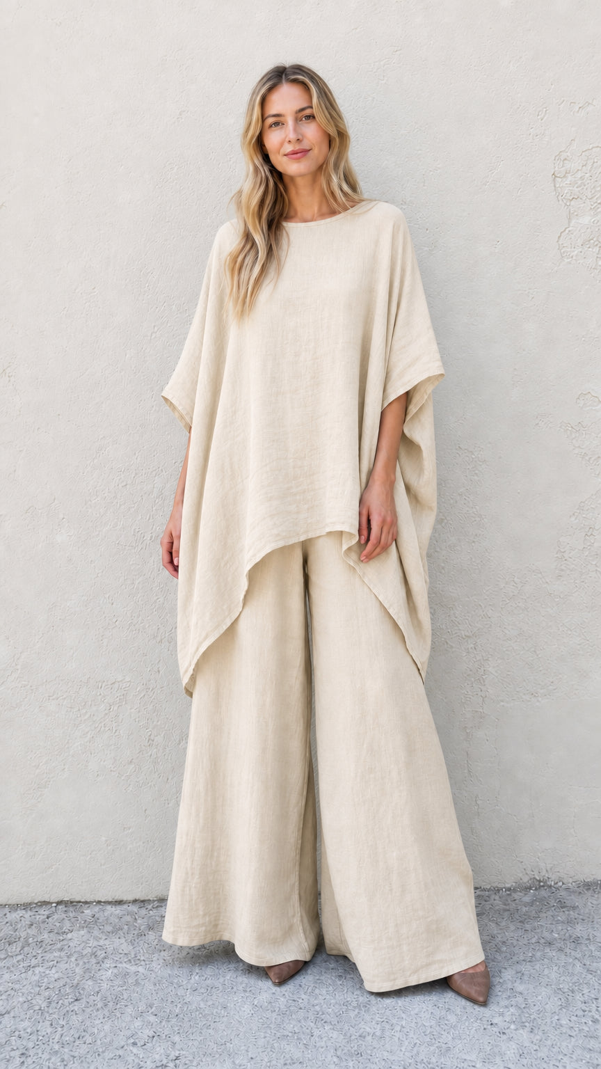 Woman wearing beige two-piece poncho and wide leg pants set