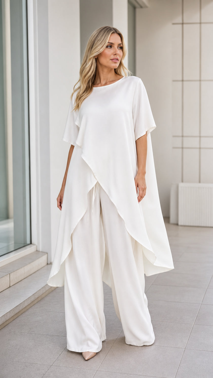 Model wearing white asymmetric tunic and wide-leg pants set, front view
