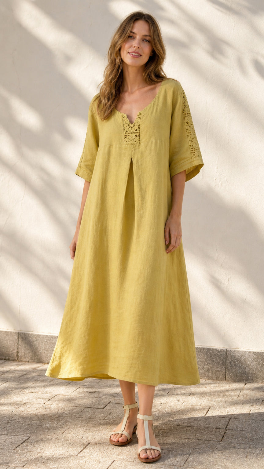 Front view of model wearing yellow midi dress with crochet details