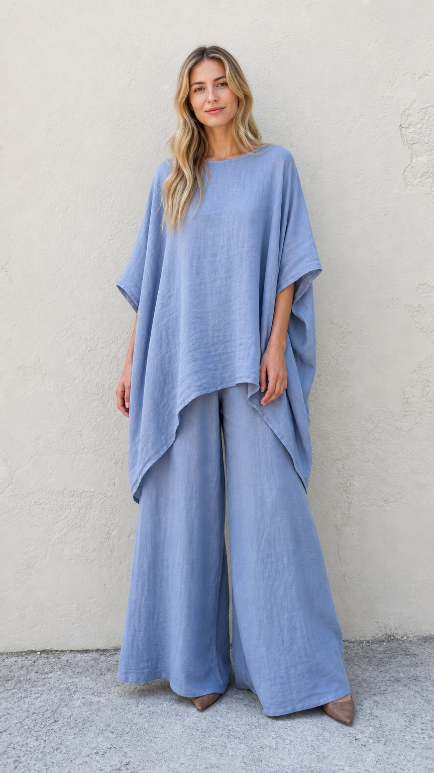 Front view of woman wearing blue poncho top and matching wide leg pants set