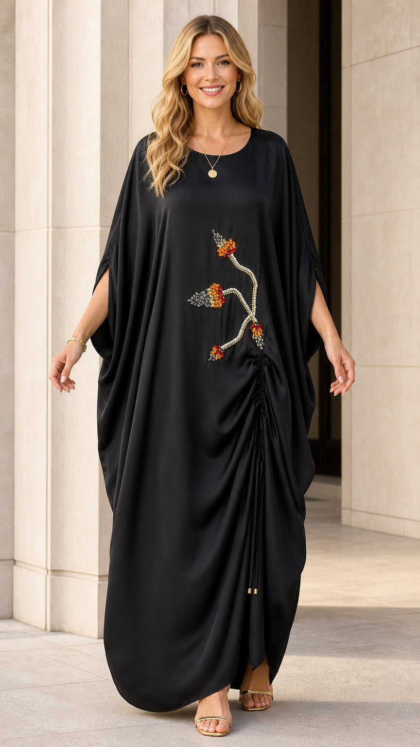 Model wearing black kaftan maxi dress with beaded embroidery