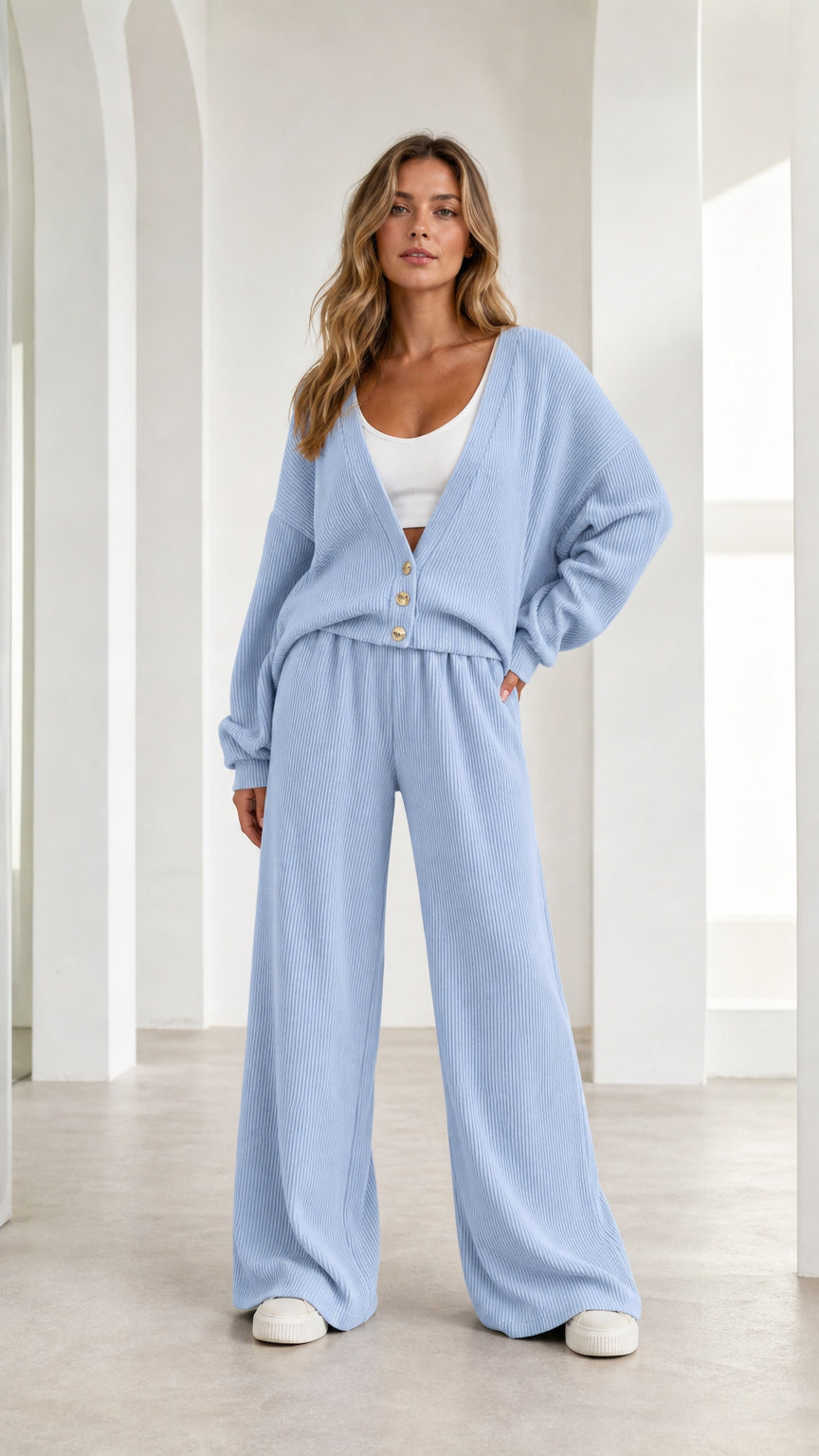 Woman wearing light blue ribbed knit cardigan and wide leg lounge pants, front view