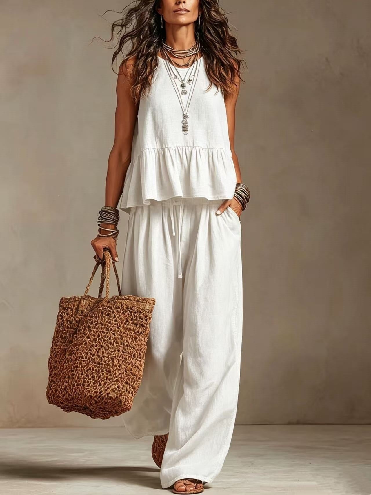 Woman wearing white boho sleeveless peplum top and wide leg pants set