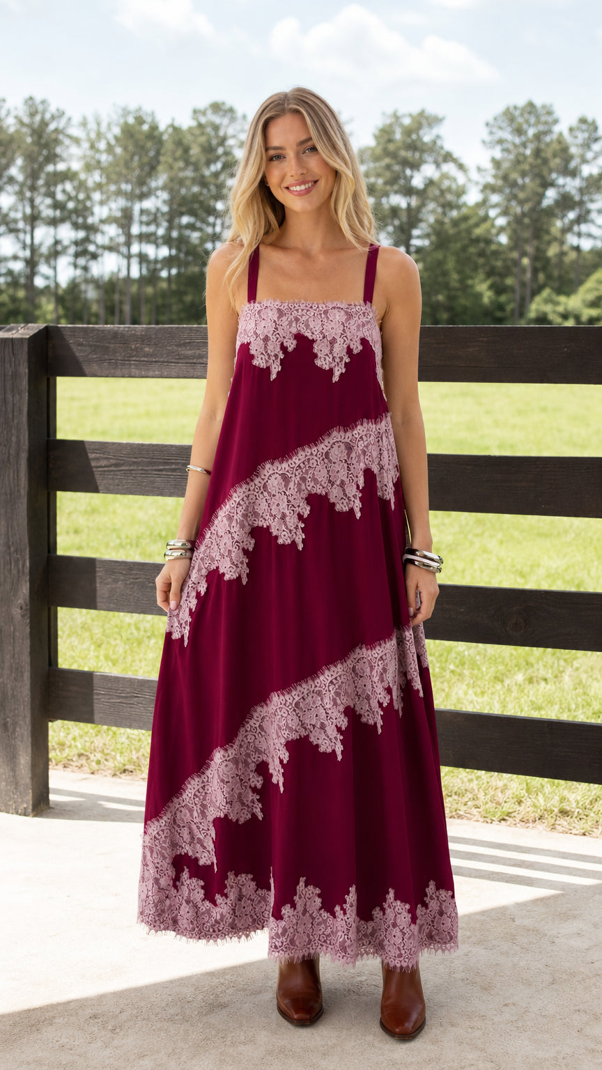 Woman wearing burgundy boho lace trimmed maxi dress standing outdoors