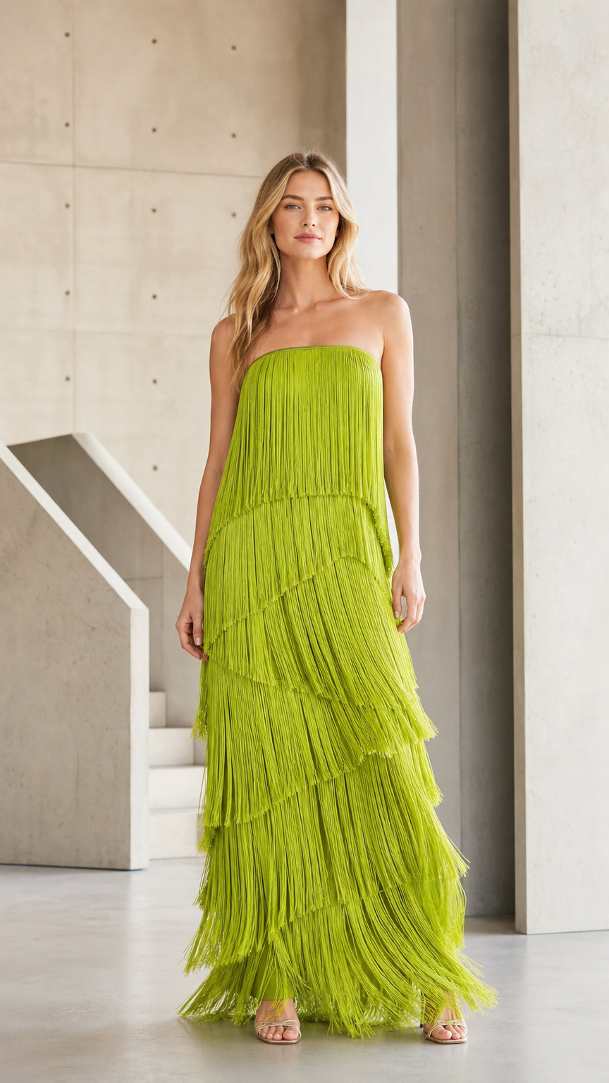Front view of model wearing chartreuse tiered fringe strapless maxi dress