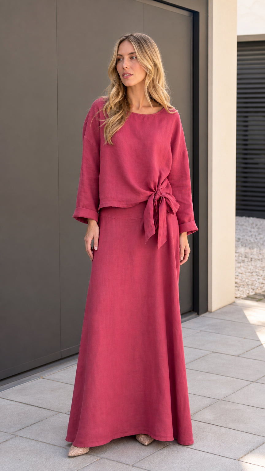 Front view of model wearing rose red two-piece knot top and maxi skirt set