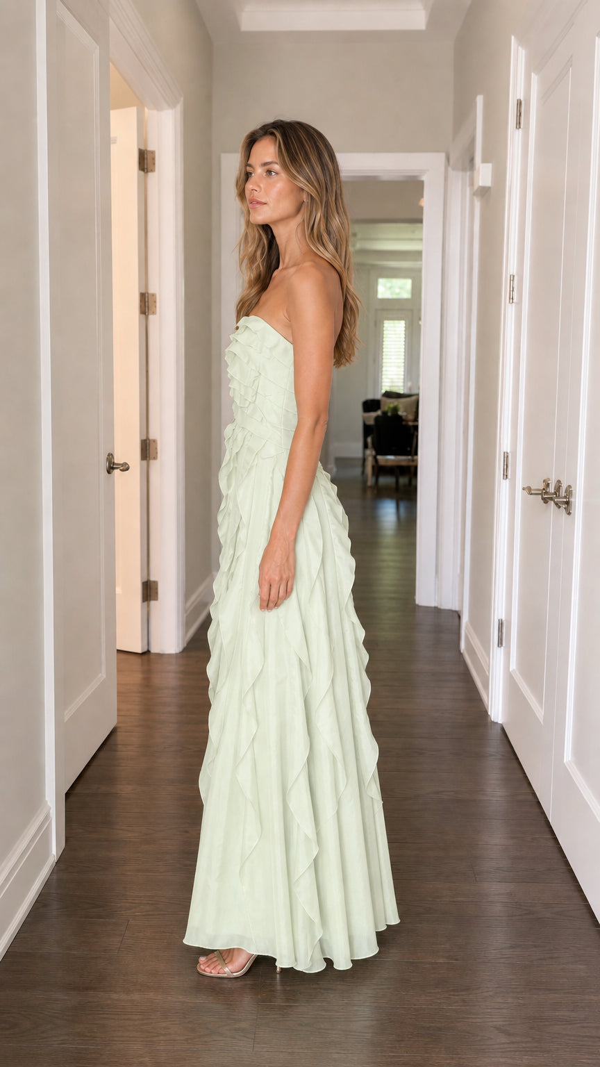 Side profile of model in sage green ruffle maxi dress