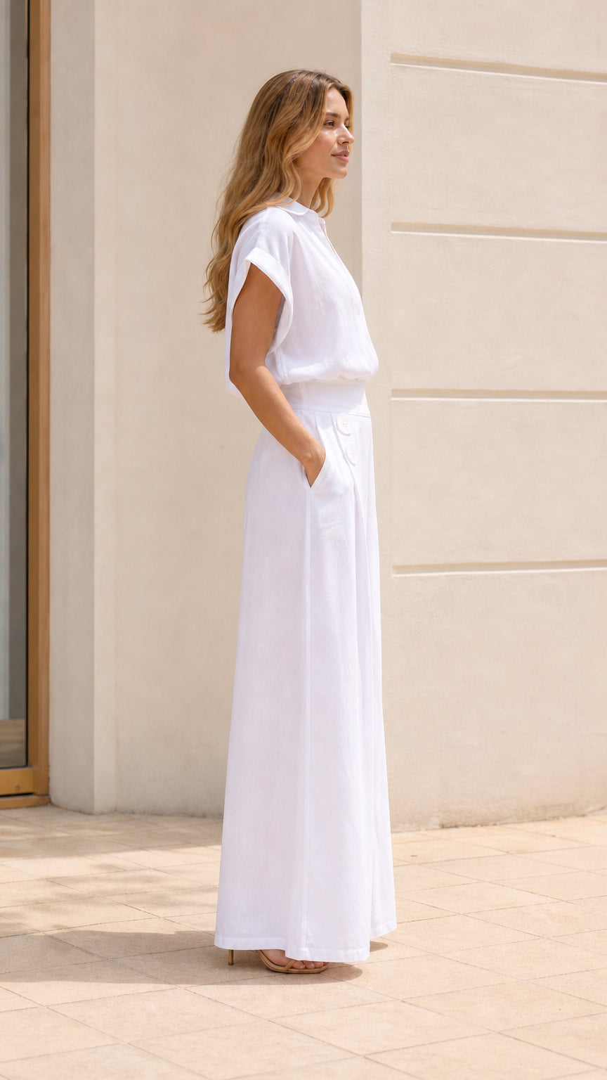 Side profile of woman wearing white jumpsuit