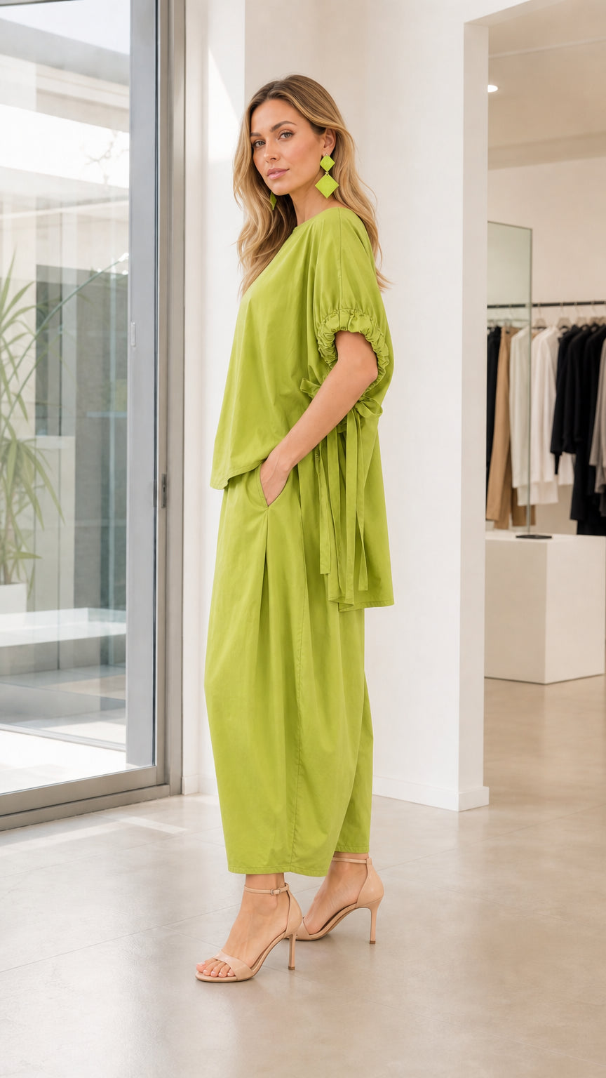 Model wearing lime green two-piece set, side profile