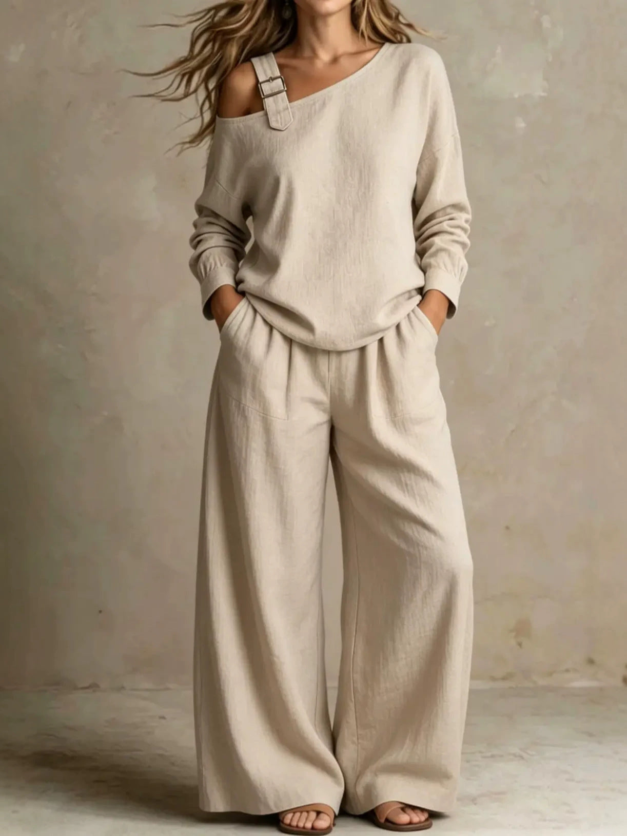 Woman wearing beige asymmetric buckle top and wide-leg pants lounge set