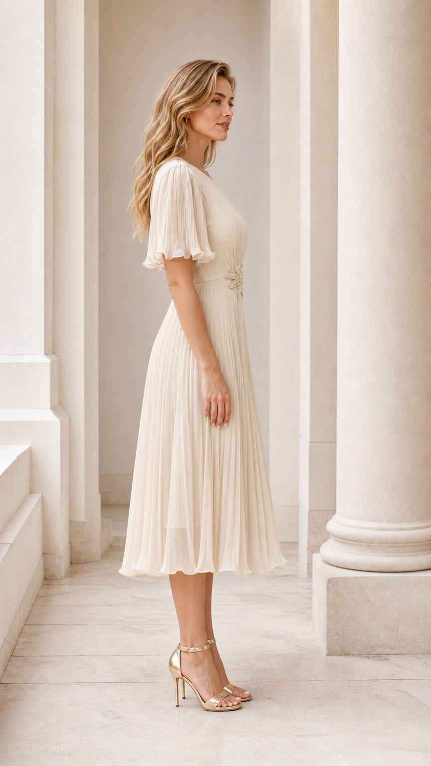 Side profile view of the champagne pleated midi dress