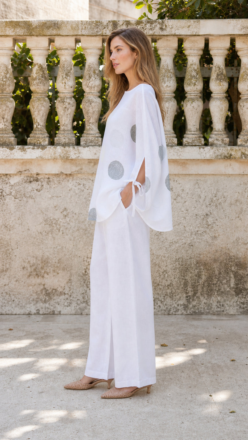 Side profile of woman in white two-piece outfit set