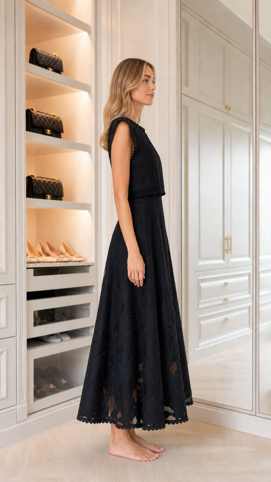 Side profile of woman in black embroidered maxi dress