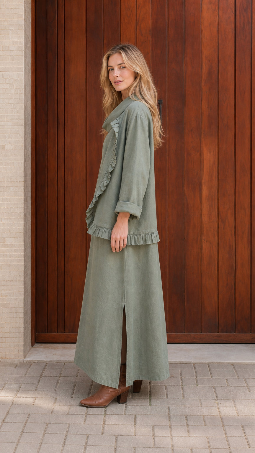Side profile of model in sage green two piece set with ankle boots