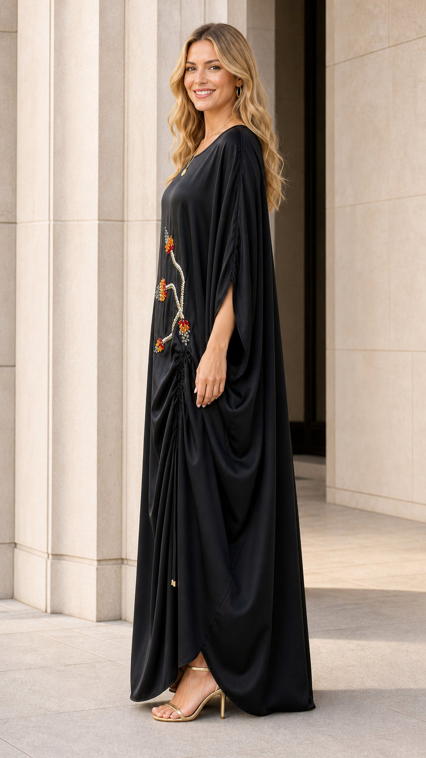 Side profile of black kaftan dress showing draped fit
