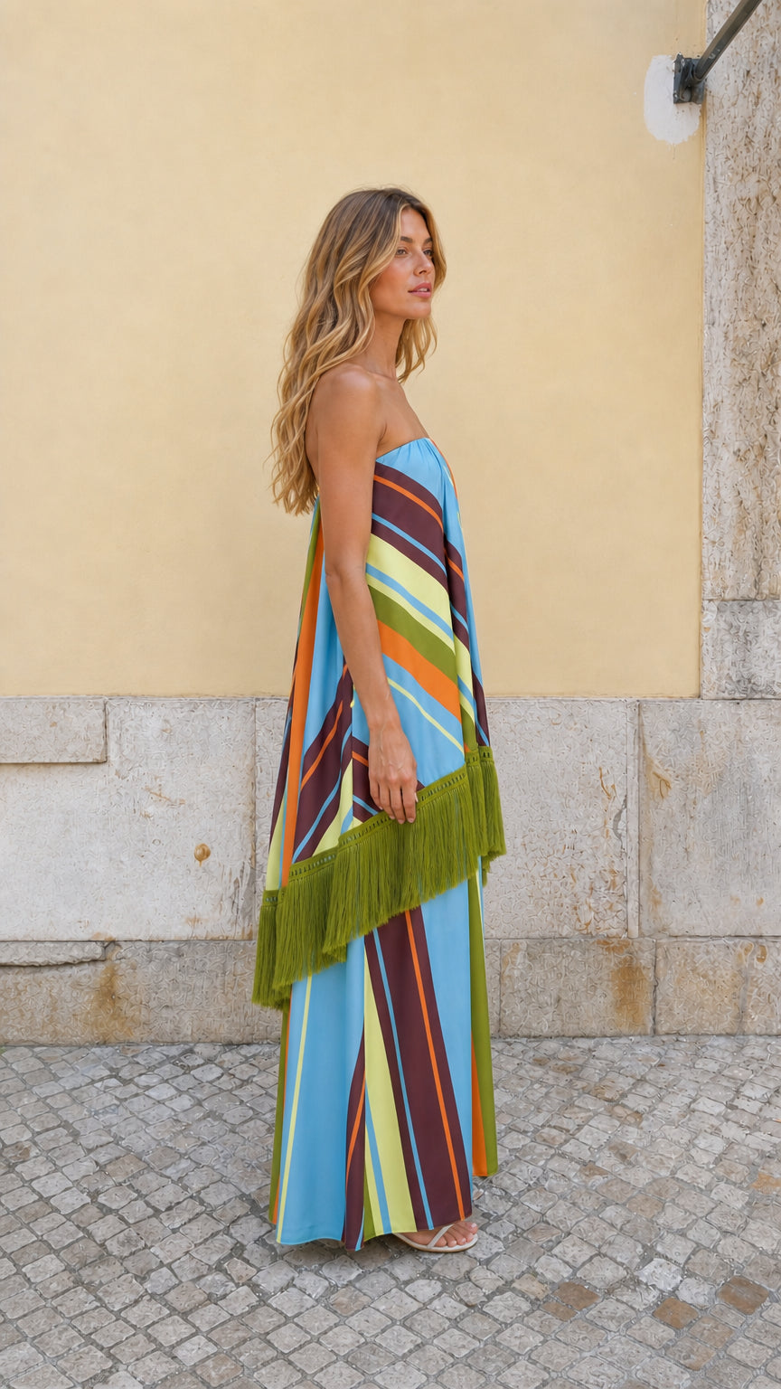 Side profile view of Blue Multi striped strapless fringe maxi dress