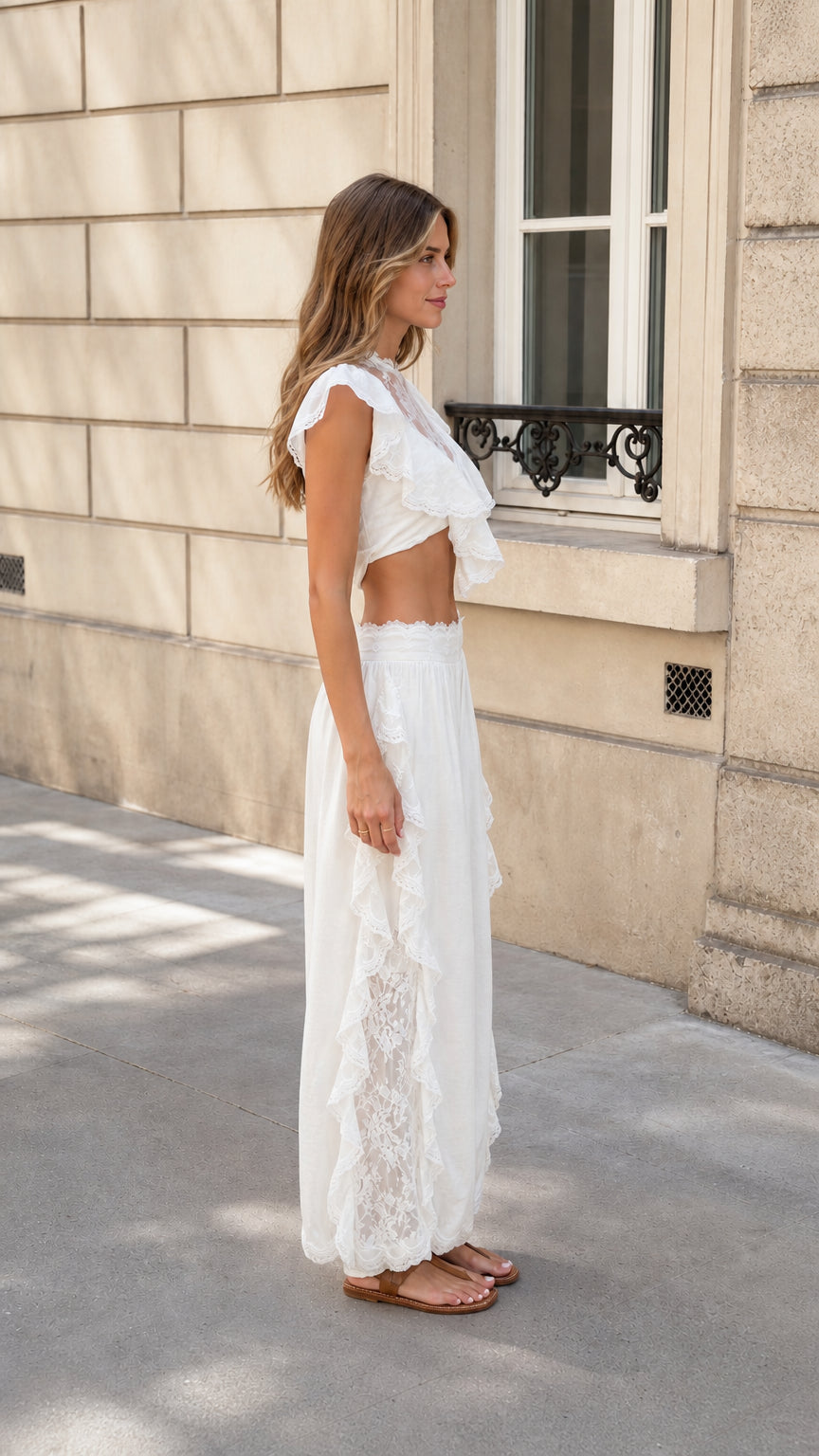 Side profile view of woman in white lace two-piece set outdoors