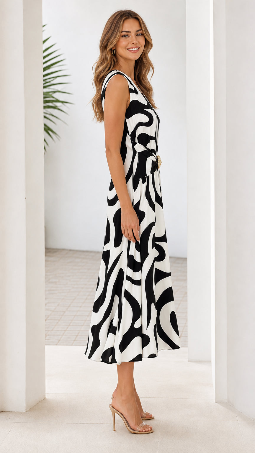 Side profile view of black and white abstract print midi dress