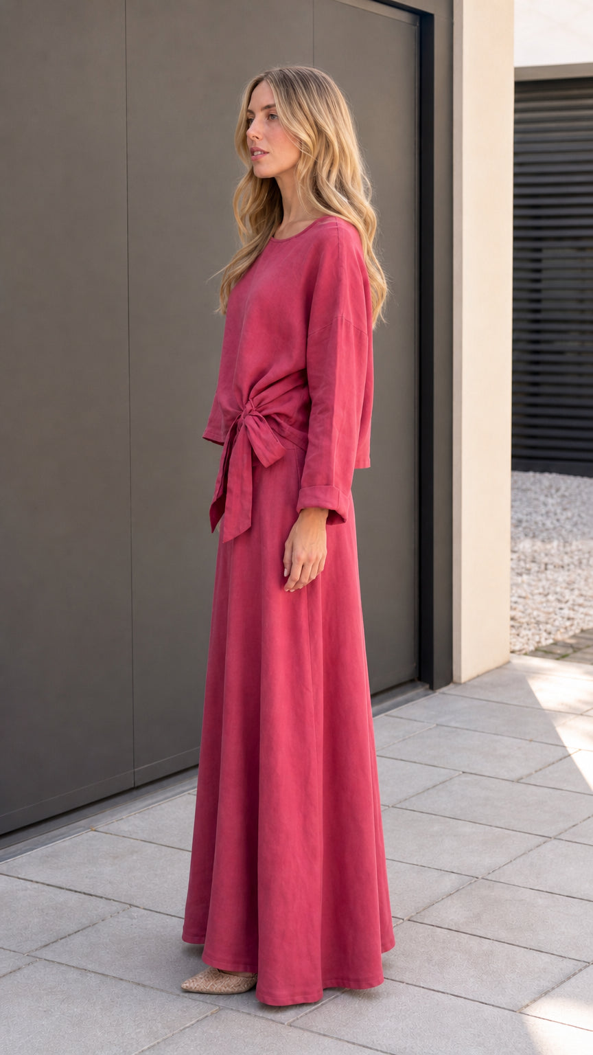 Side profile view of model in rose red matching set