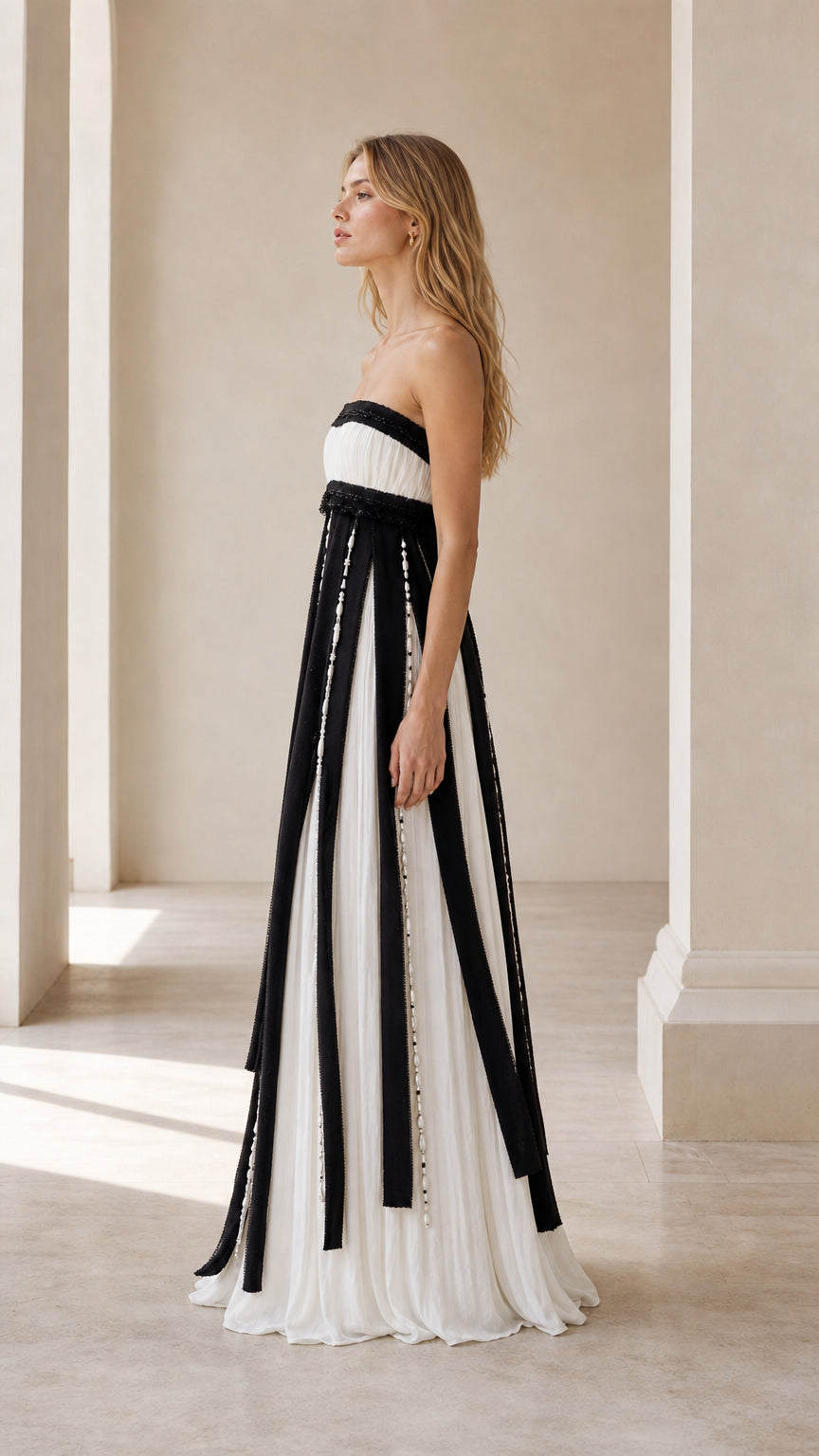 Side profile view of black and white strapless evening gown