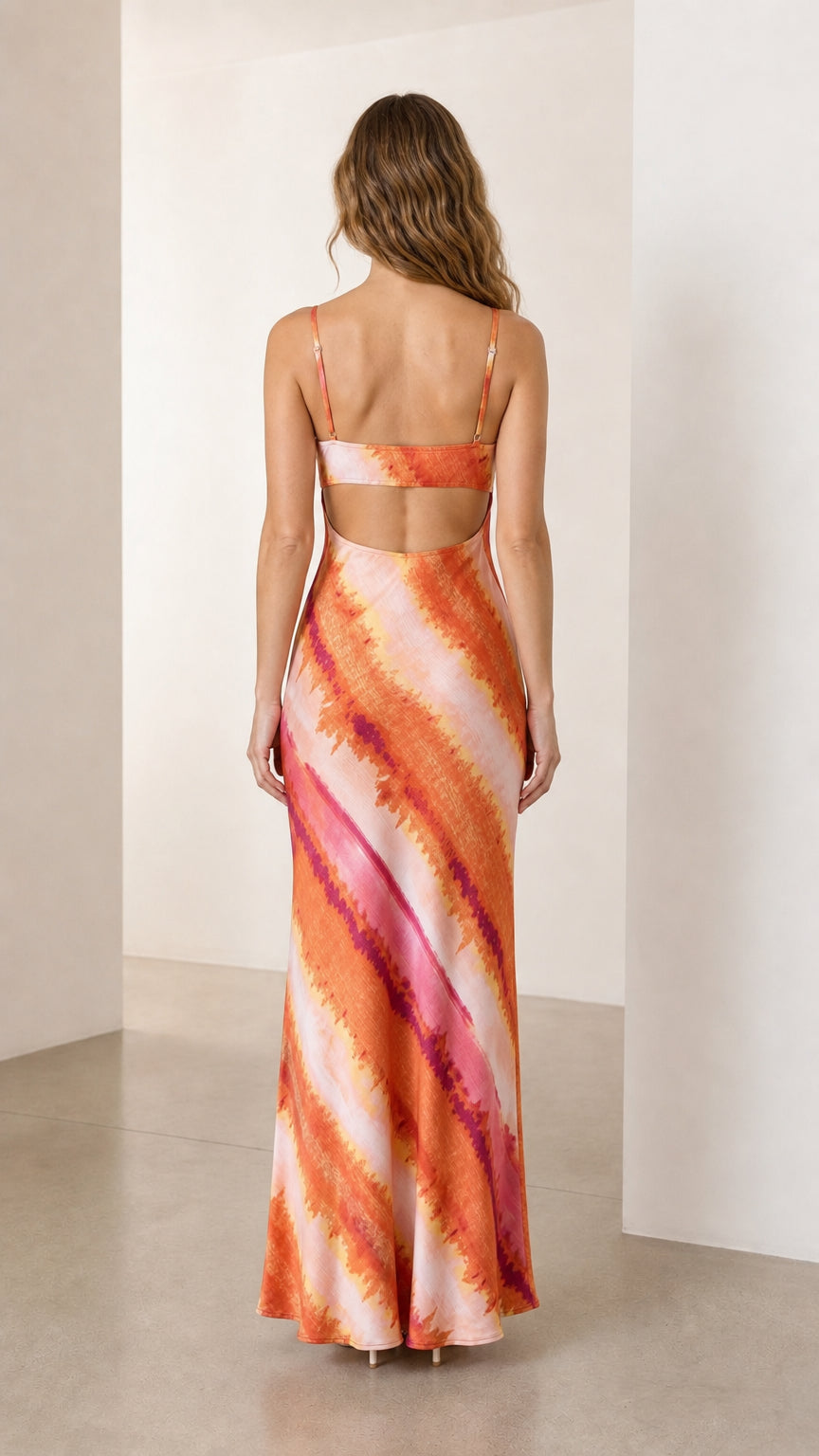 Back view showing open back design on orange tie-dye dress