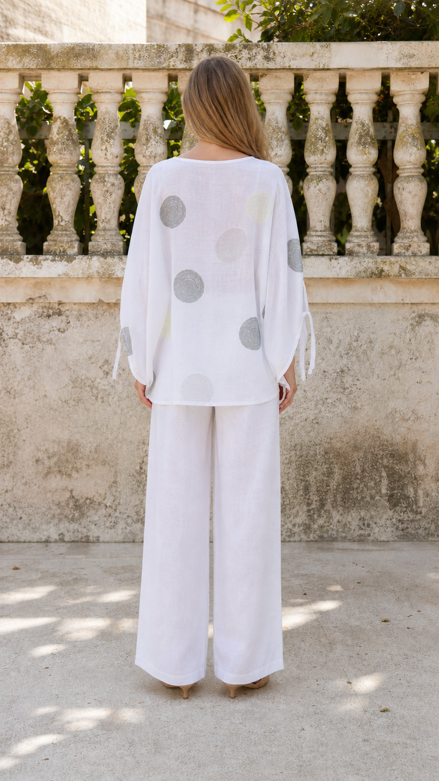 Back view of woman wearing white matching set