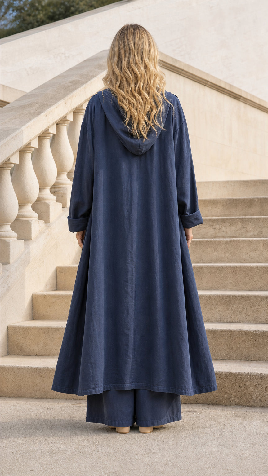 Back view of model in Navy Blue hooded cardigan showing flowing drape