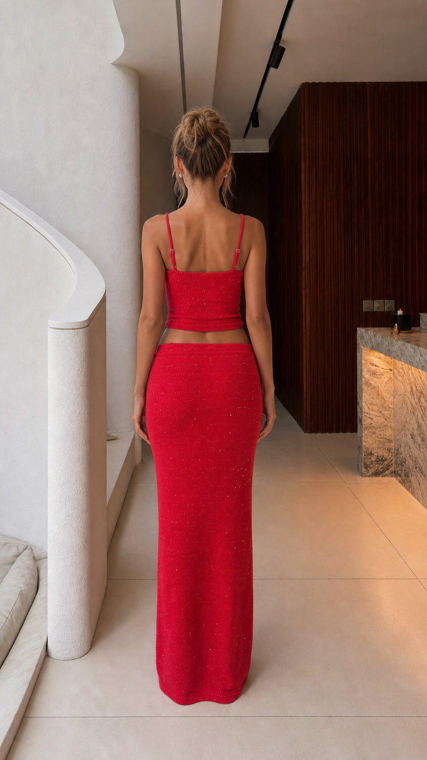 Back view of model wearing red sparkle knit crop top and maxi skirt