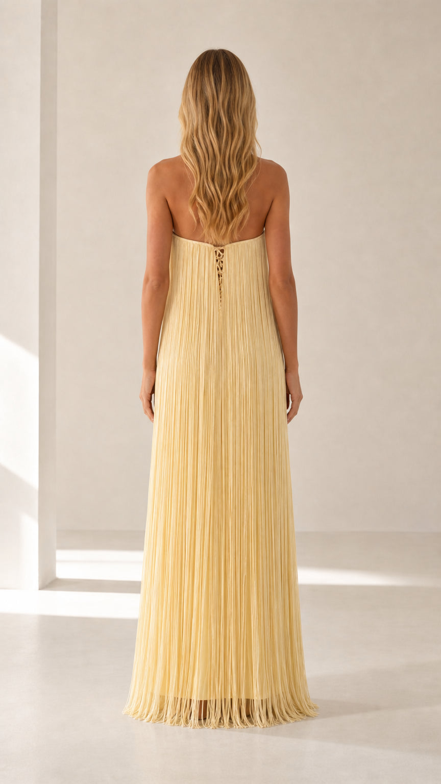 Back view showing lace-up closure on yellow maxi dress