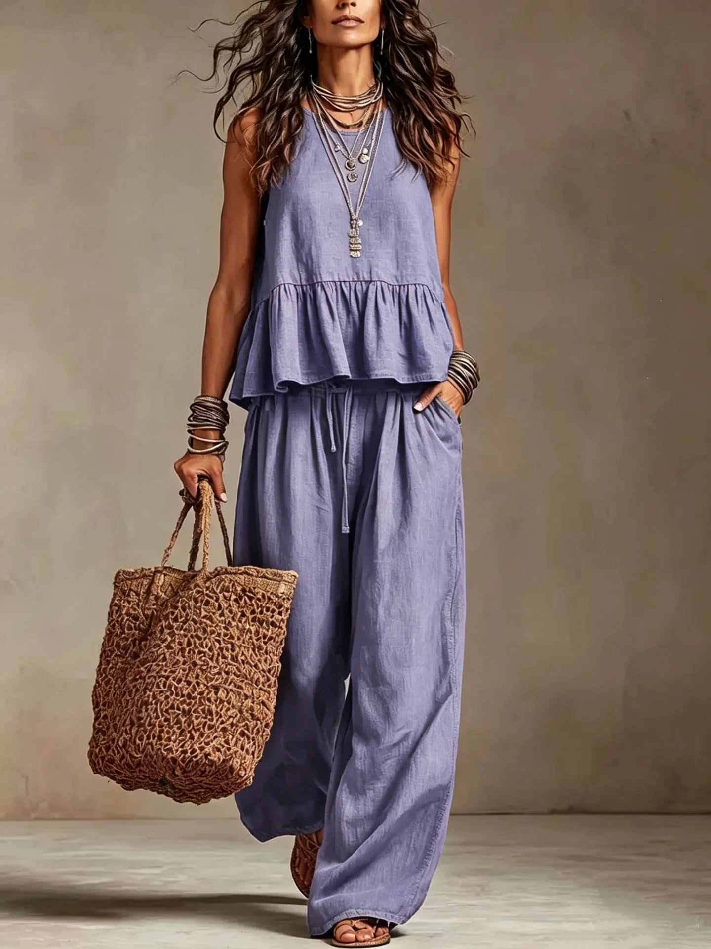 Woman wearing lavender boho sleeveless peplum top and wide leg pants set
