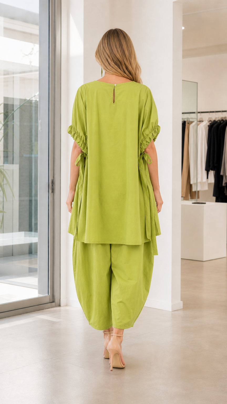 Model wearing lime green two-piece set, back view