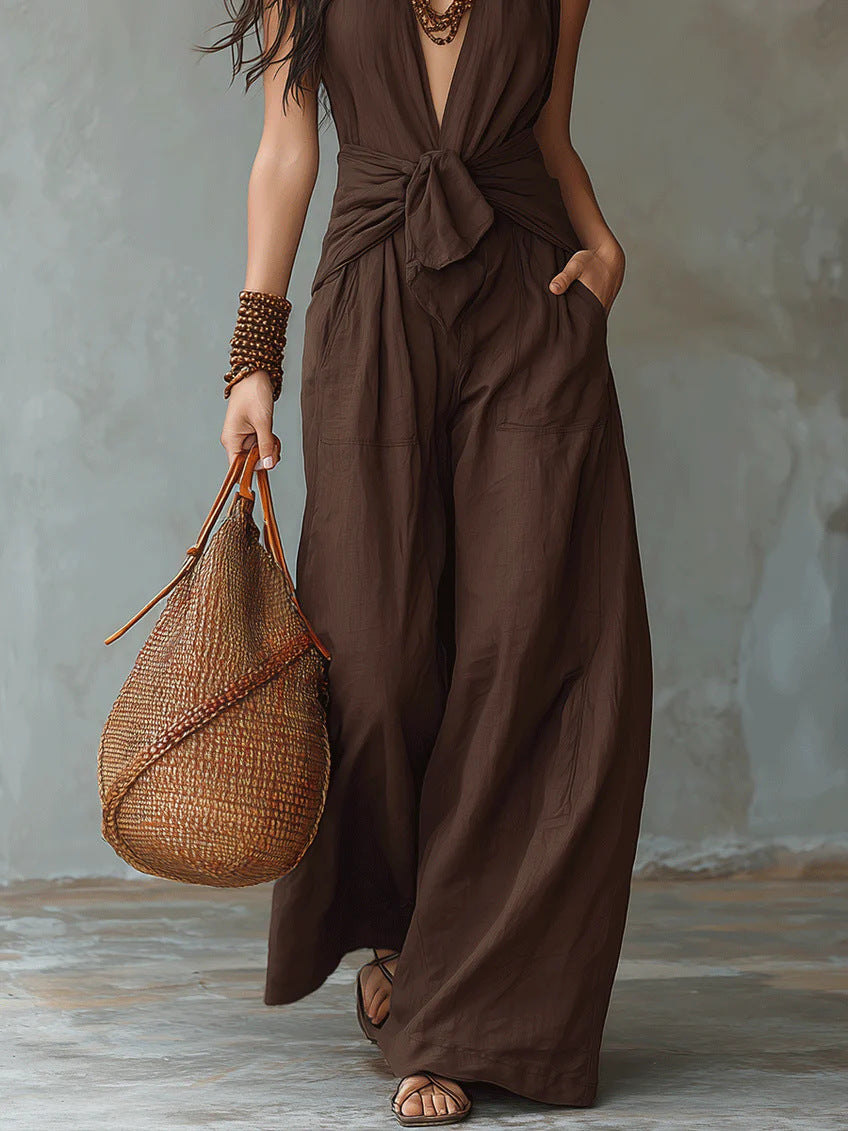 Model wearing dark brown halter tie waist wide leg jumpsuit