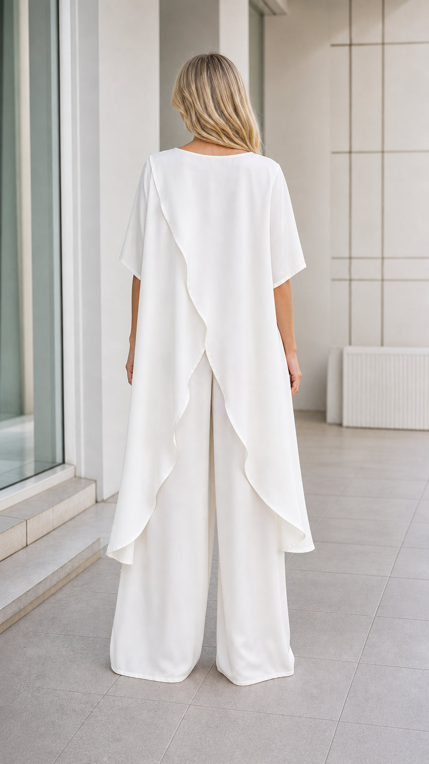 Model wearing white pant set, back view