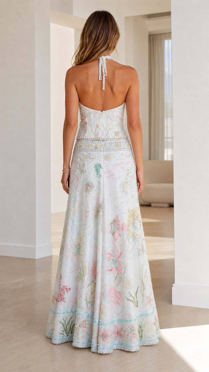 Back view of woman wearing white halter neck maxi skirt set
