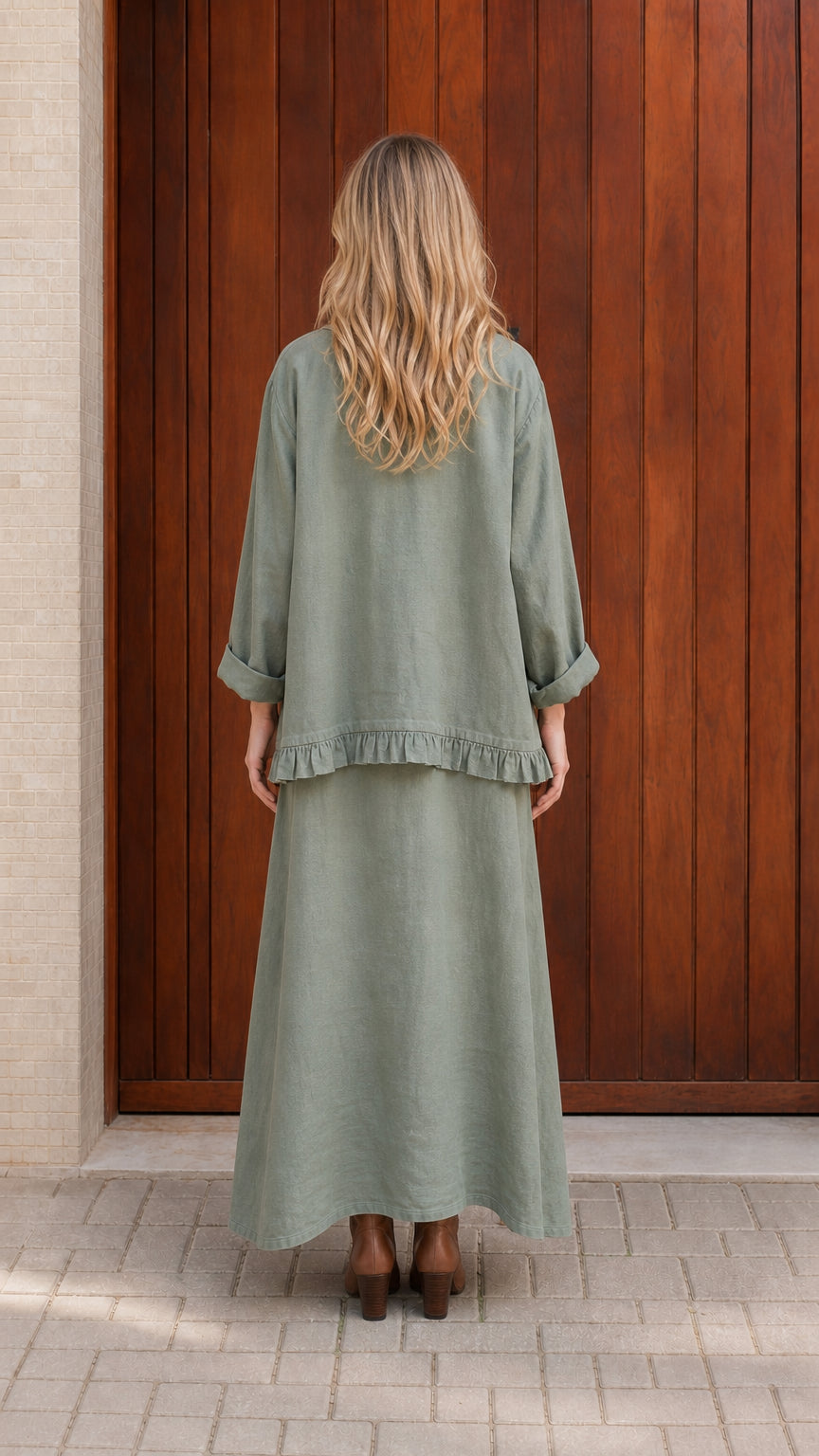 Back view of model wearing sage green maxi skirt set