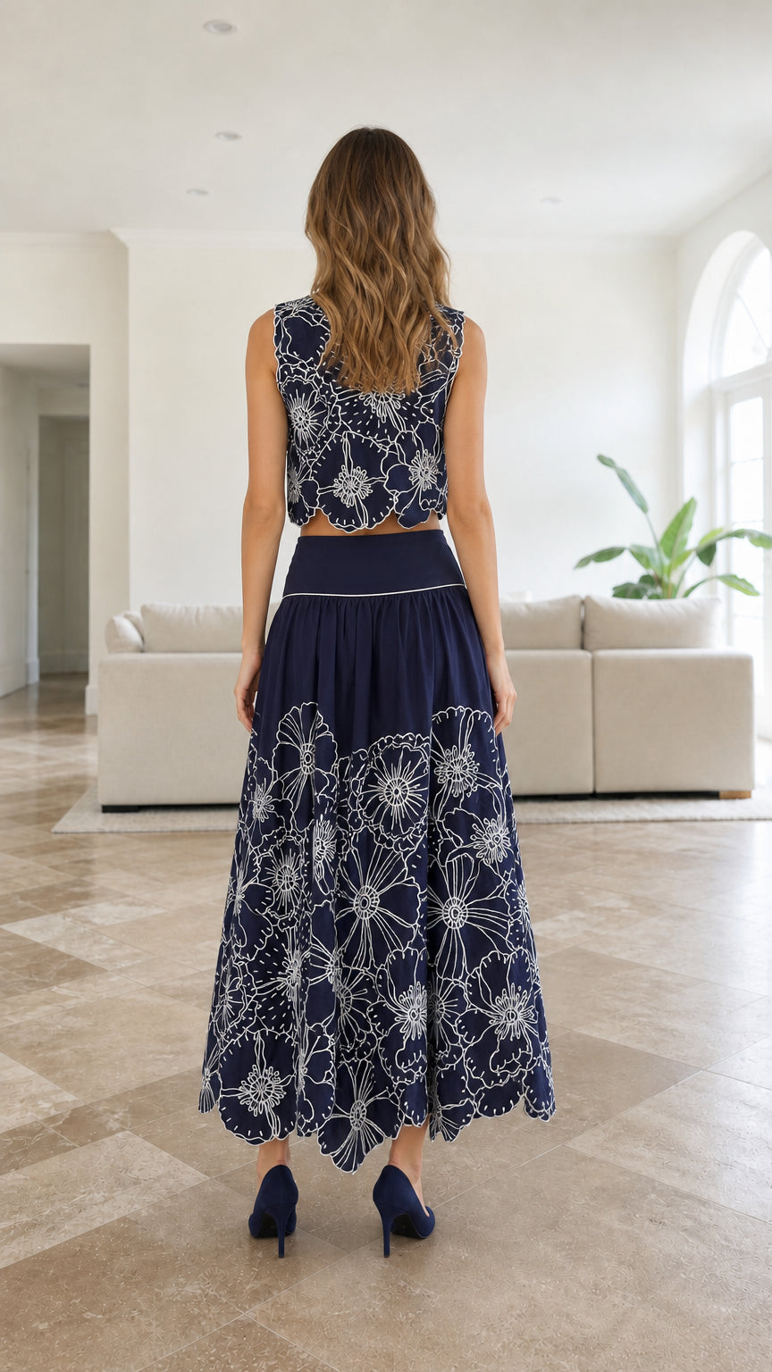 Back view of model wearing navy floral embroidered maxi skirt set