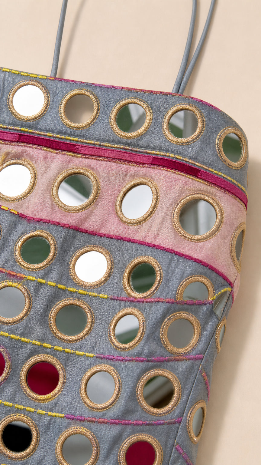 Close-up detail of mirrorwork embroidery and fabric texture