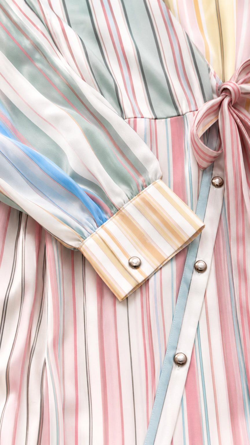 Close-up of sleeve cuff and wrap tie detail on striped dress