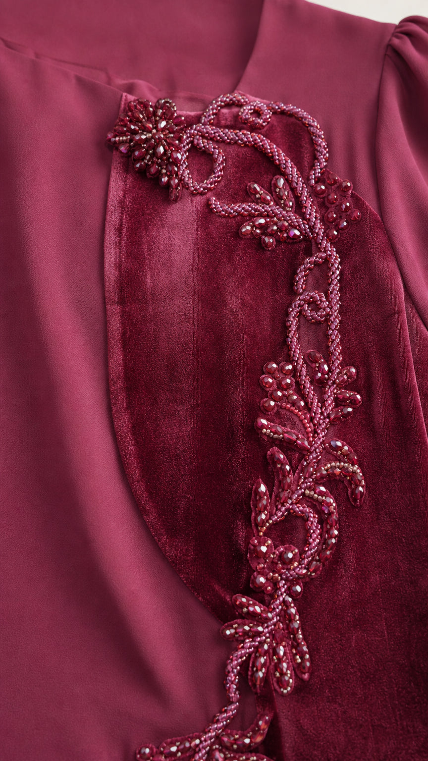 Close-up of beaded applique and velvet trim on dress bodice
