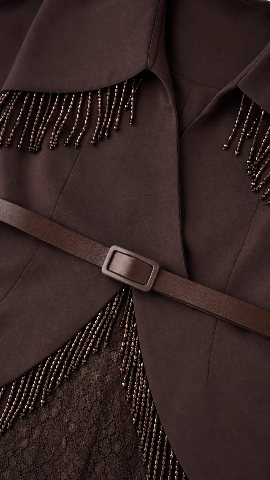 Close-up detail of beaded fringe and belt on brown gown