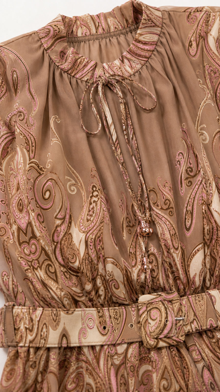 Close-up of neckline and belt detail on camel dress
