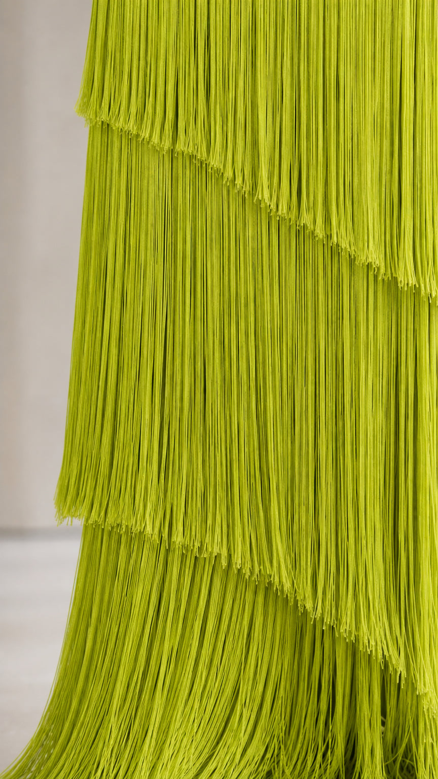 Close-up detail of tiered fringe layers in chartreuse