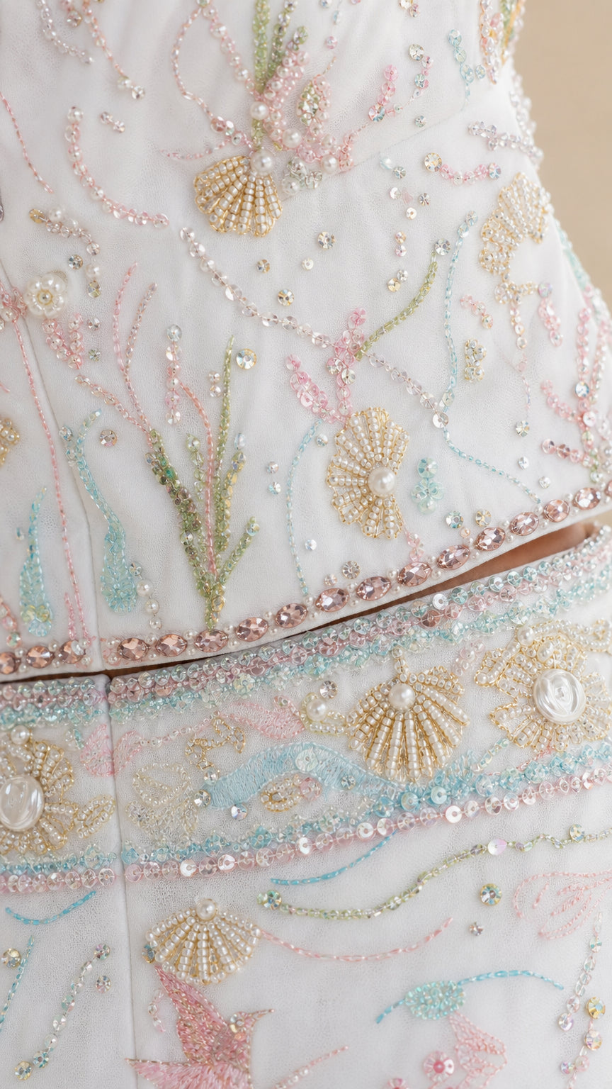Close-up detail of sequin, pearl, and aquatic embroidery on white set