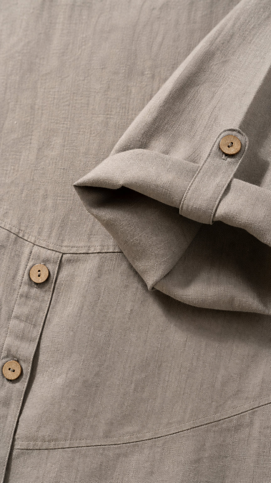 Close-up detail of fabric texture, side buttons, and sleeve cuff tab