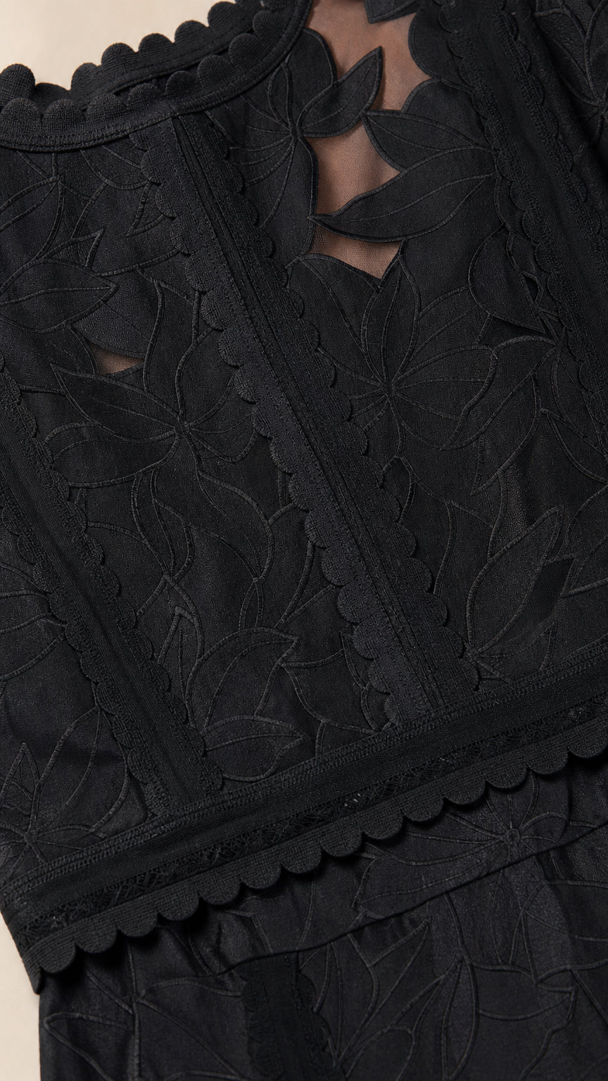 Close up of black dress neckline and embroidery pattern
