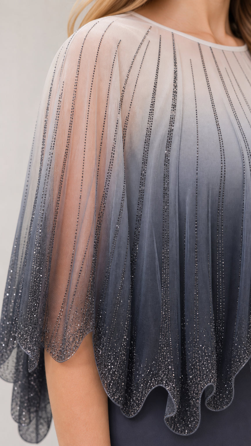 Close-up detail of sheer beaded ombre capelet overlay