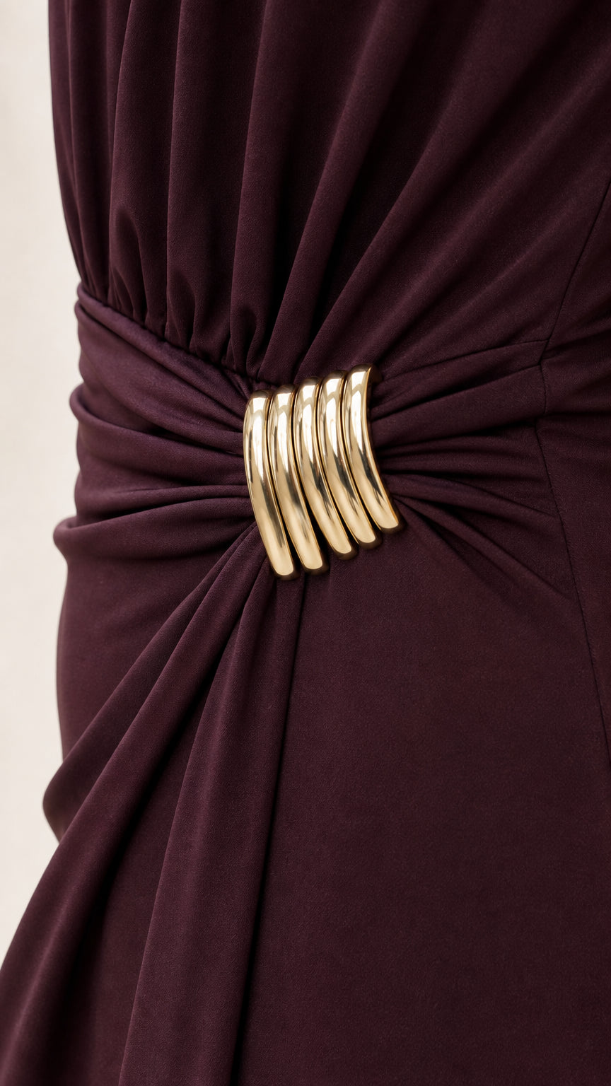 Close-up detail of gold ring hardware on ruched waist