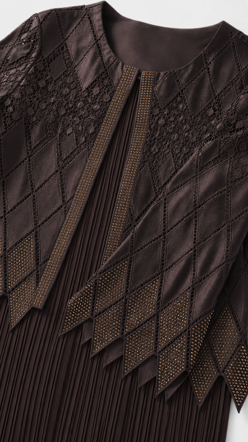 Close-up detail of embroidery and pleating on dark brown jacket